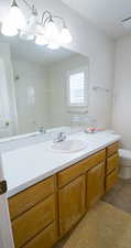 Full bath featuring vanity, light tile patterned floors, and a shower
