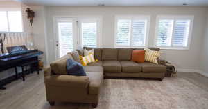 Living room featuring light wood-style flooring and baseboards