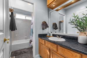 Bathroom featuring vanity and shower / bath combo