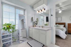 Bathroom featuring vanity, a ceiling fan, connected bathroom, curtained shower, and light floors