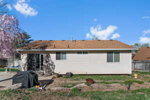 Back of house featuring a fenced backyard and a patio