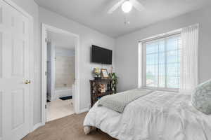 Bedroom featuring light carpet and a ceiling fan