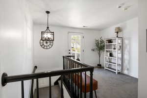 Staircase with carpet flooring and baseboards