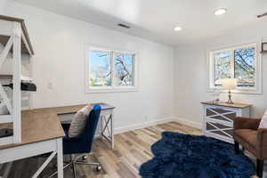 Office area featuring light wood-style flooring, healthy amount of natural light, and recessed lighting
