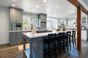 Kitchen with ornamental molding, decorative backsplash, recessed lighting, dark wood-style flooring, and gray cabinets