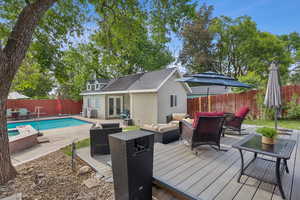 Wooden terrace with french doors, an outdoor living space, a patio, and a fenced backyard