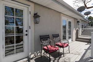 Wooden terrace featuring french doors