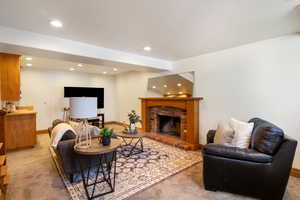 Carpeted living area with a fireplace and recessed lighting