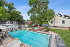 Swimming pool with a patio area, an in-ground hot tub, and outdoor dining area