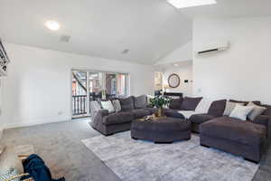 Living room featuring vaulted ceiling and carpet flooring