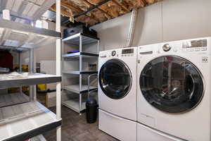 Laundry area featuring parquet floors and independent washer and dryer