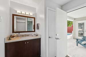 Bathroom with vanity and a shower