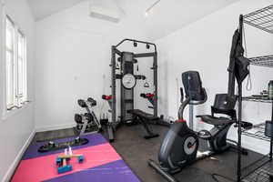 Workout room with vaulted ceiling and a mini split for heating / cooling