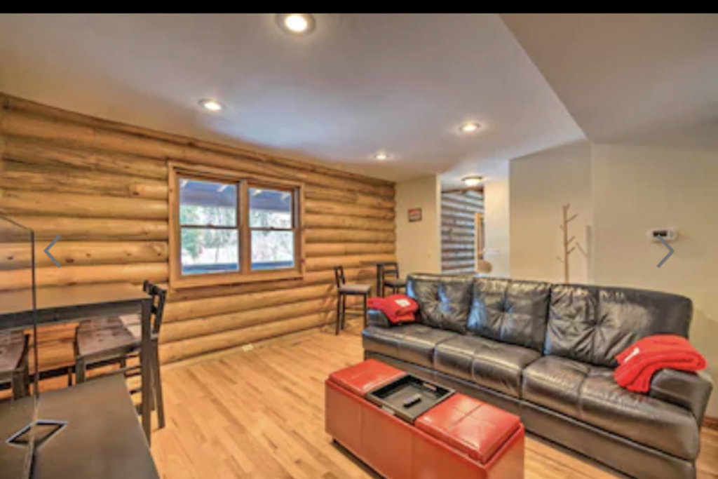 Living area with rustic walls, light wood finished floors, and recessed lighting