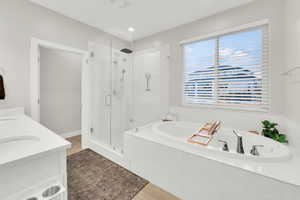 Primary Bedroom Bathroom features separate soaking tub and walk in shower.
