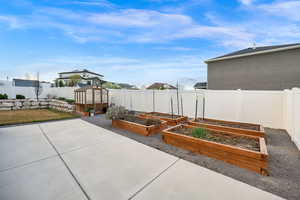 Raised garden beds with culinary watering system.  Some herbs and strawberries are already planted