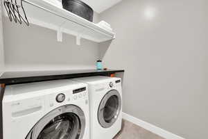 Laundry room with folding table, hanging bar, sink and cabinets