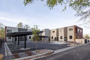 View of building exterior with uncovered parking