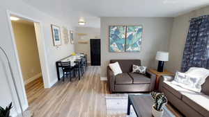 Living area featuring light wood-type flooring and baseboards