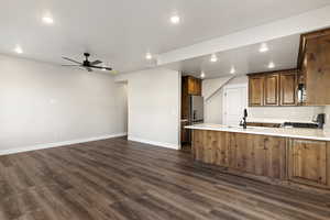 Kitchen featuring recessed lighting, wood finish cabinets, a peninsula, a ceiling fan, and stainless steel appliances