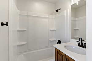 Bathroom with vanity and bathing tub / shower combination