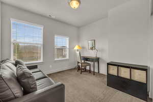 Living area with carpet flooring and baseboards