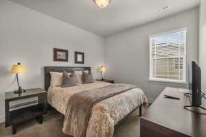 Bedroom featuring dark carpet