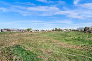 View of grassy yard with a mountain view and a view of countryside
