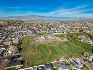 Aerial overview of property's location featuring nearby suburban area and a mountain backdrop