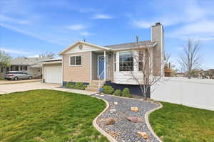 Ranch-style house with a chimney, a garage, and driveway