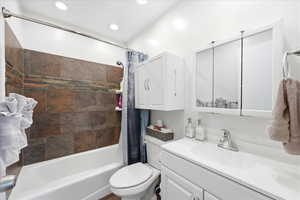 Bathroom featuring vanity and shower / tub combo with curtain