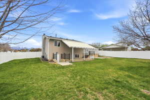 Rear view of property featuring a chimney, a patio area, and a fenced backyard
