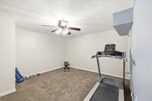 Workout area with carpet and ceiling fan