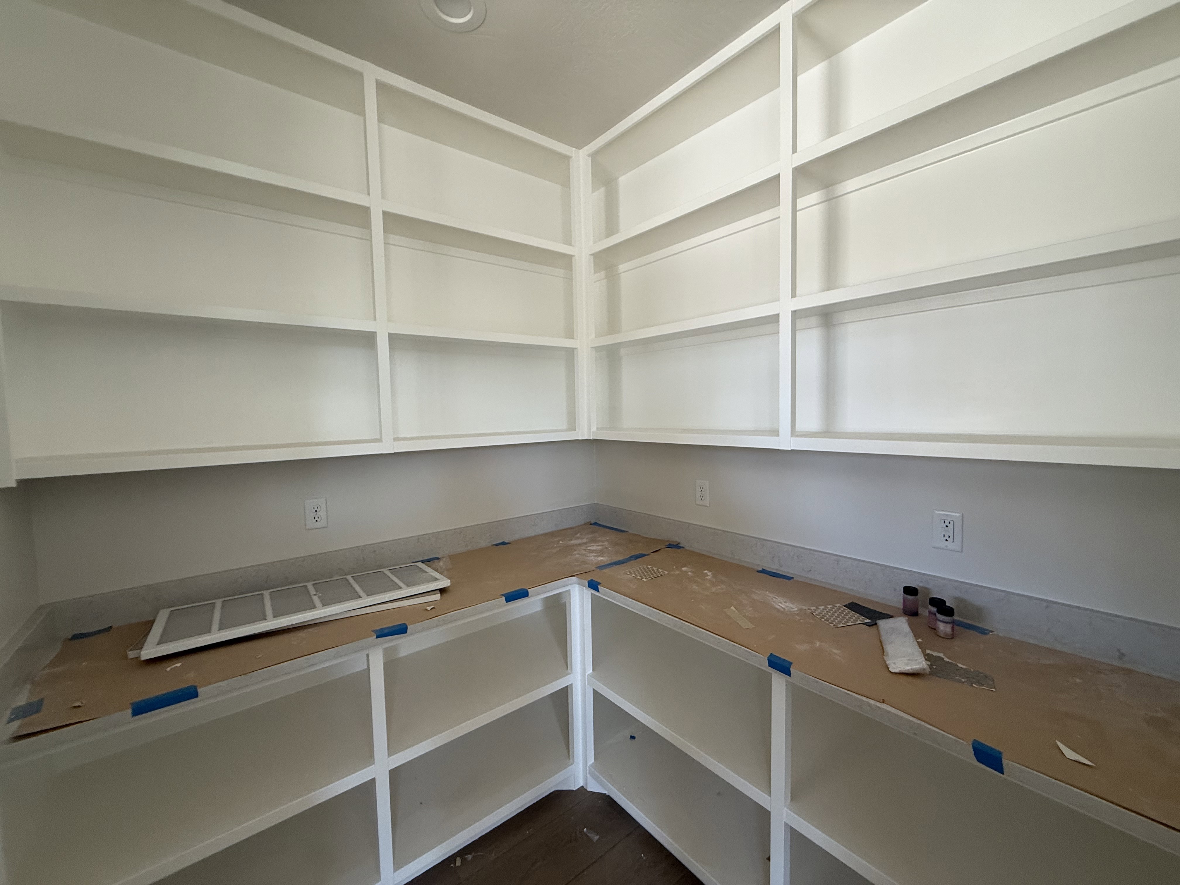 Built-in white shelving and cabinetry with light-toned countertops