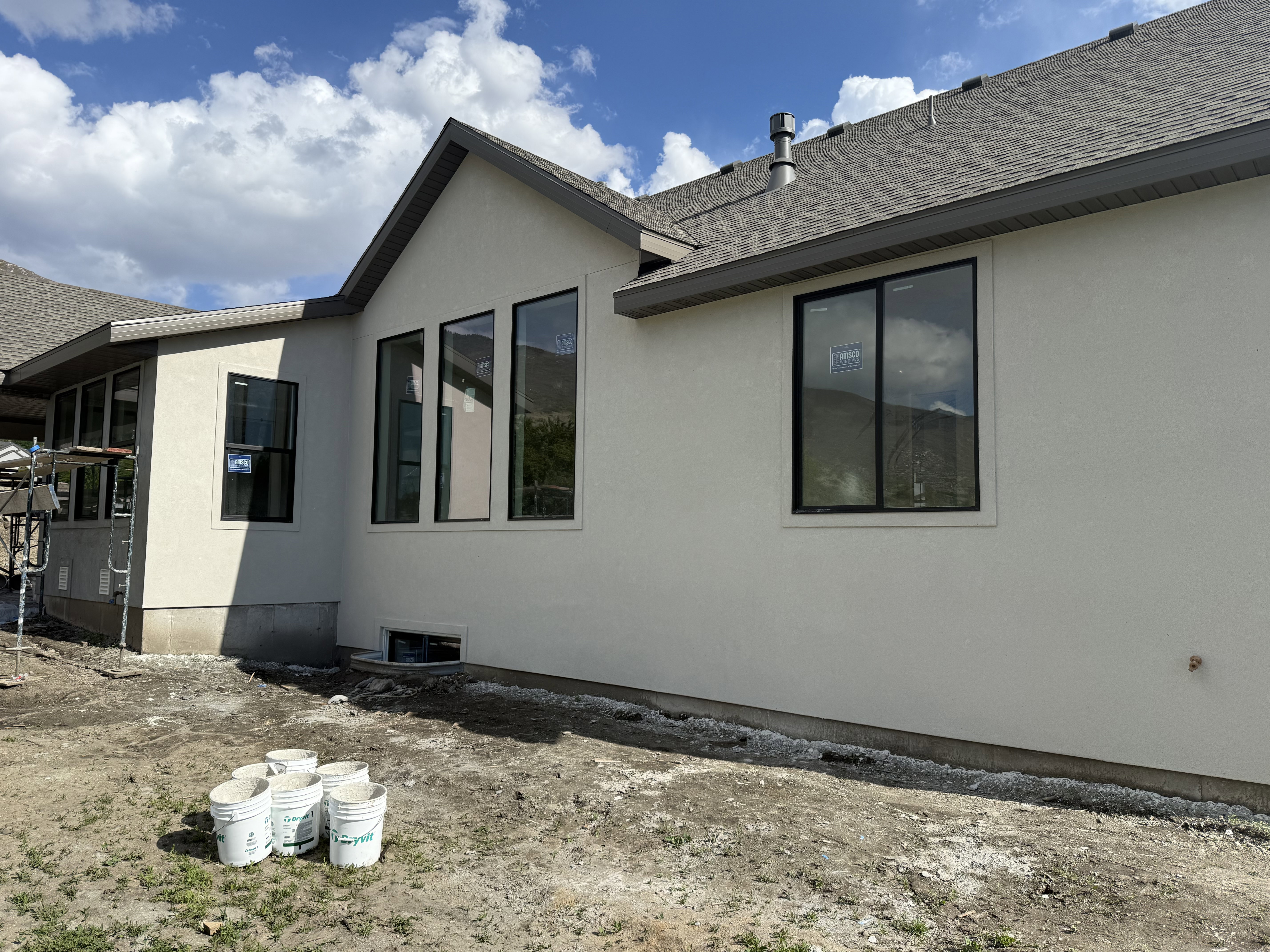 View of home's exterior featuring roof with shingles and stucco siding