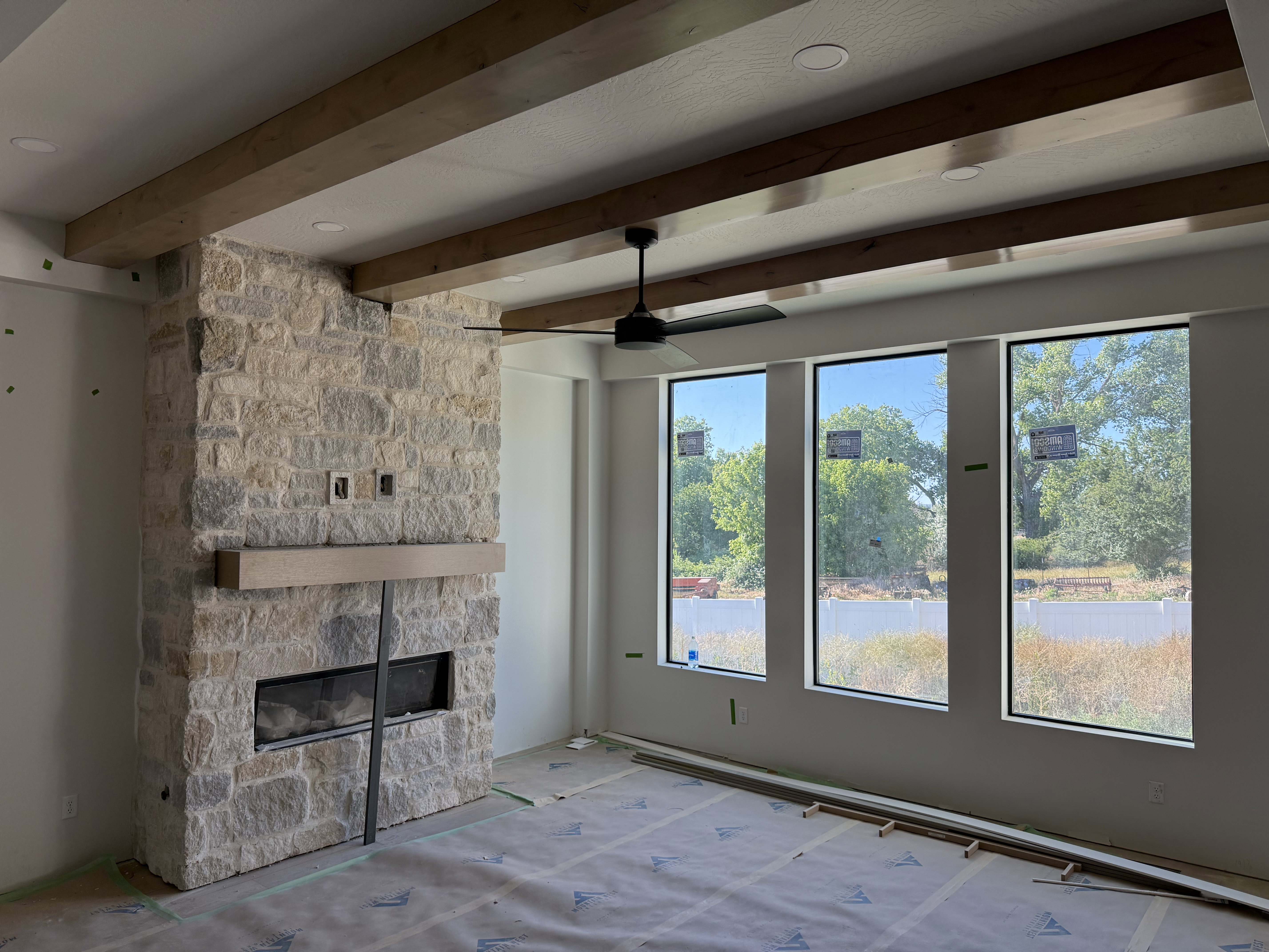 Stone-clad fireplace featuring a wood-finish mantel and a linear firebox