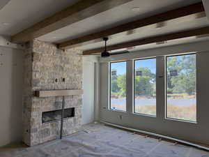 Stone-clad fireplace featuring a wood-finish mantel and a linear firebox