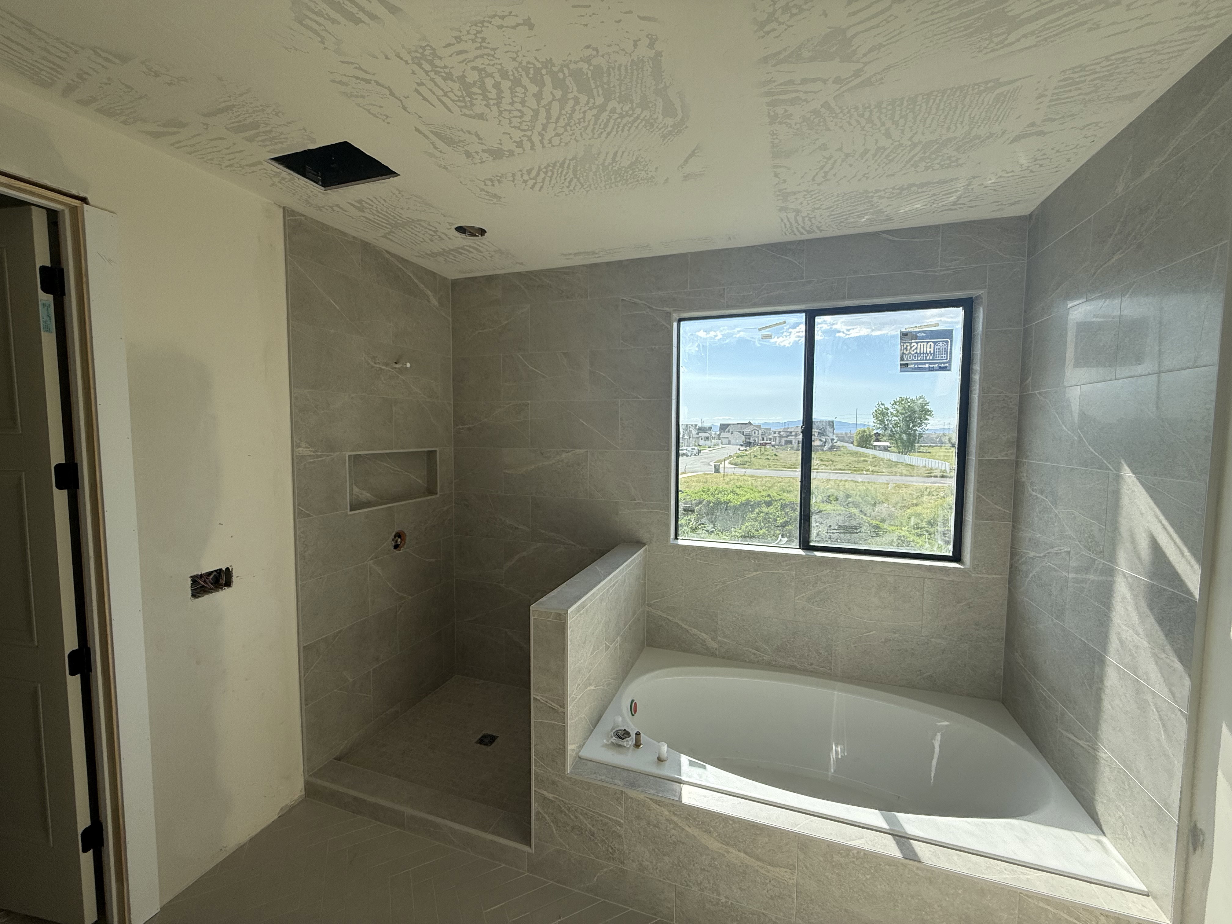 Full bath featuring tiled shower and a garden tub