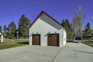 View of home's exterior with an outdoor structure and a garage