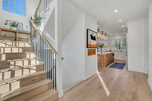 Stairs featuring hardwood / wood-style floors and recessed lighting