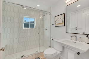 Bathroom with a stall shower and recessed lighting