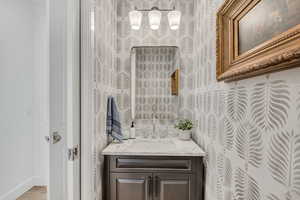 Bathroom with vanity and baseboards