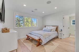 Bedroom with light wood finished floors and recessed lighting
