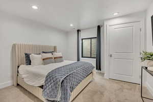 Bedroom featuring light colored carpet and recessed lighting