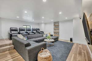 Living area featuring light wood finished floors and recessed lighting