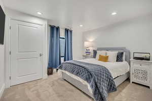 Bedroom featuring light colored carpet and recessed lighting