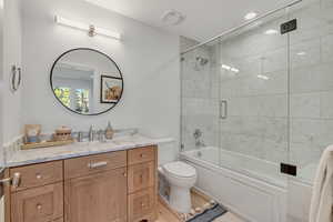 Full bathroom with vanity and combined bath / shower with glass door