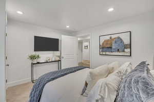 Bedroom featuring light carpet and recessed lighting