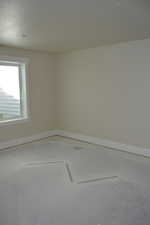 Empty room featuring baseboards