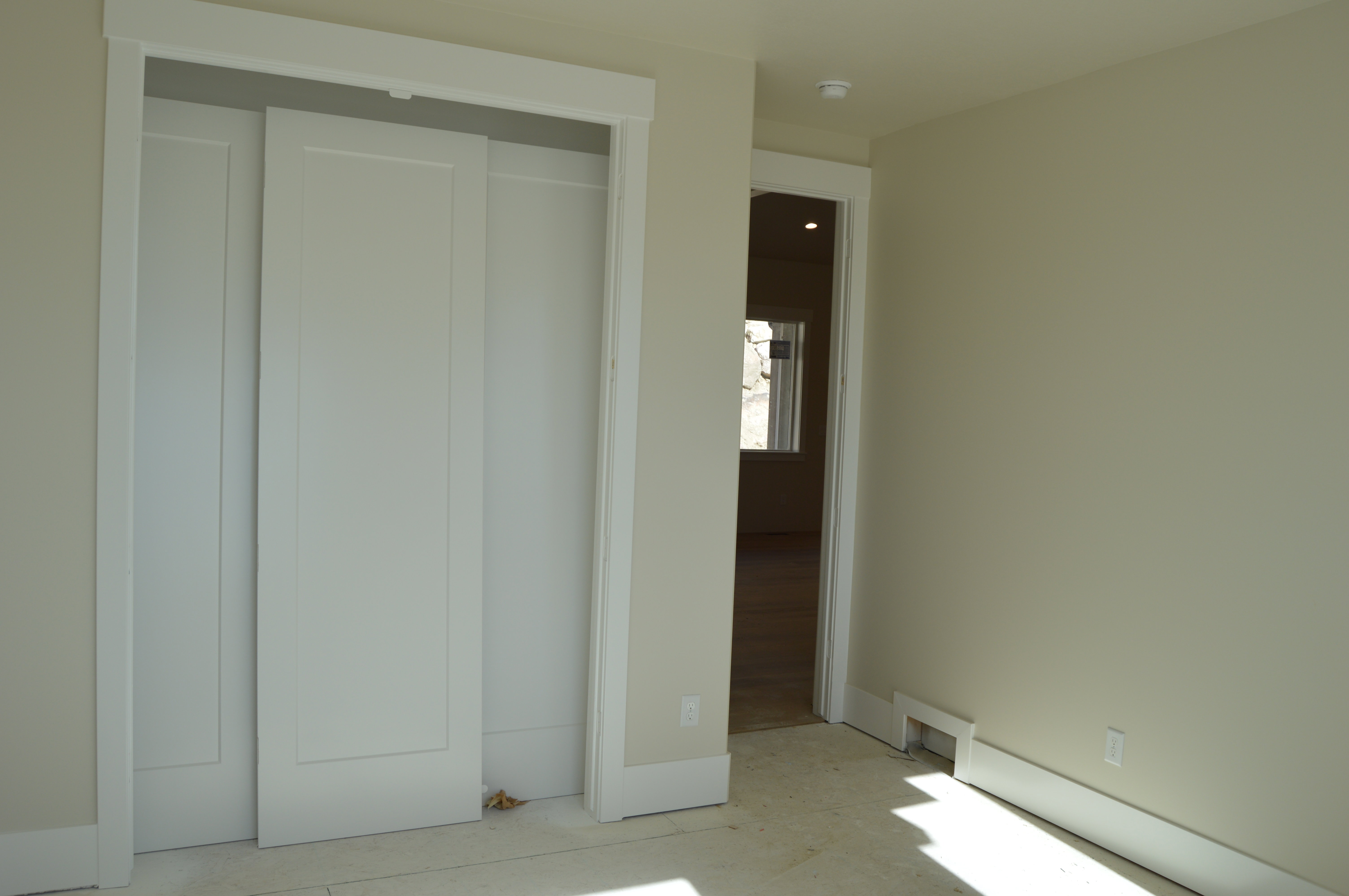 Unfurnished bedroom featuring a closet and a baseboard heating unit